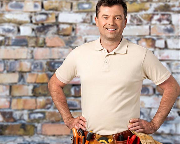 plumber in polo posing with toolbelt