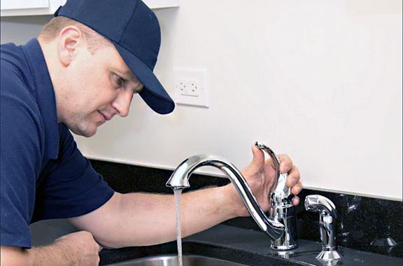 plumber in North Highlands has just finished repairing a kitchen faucet